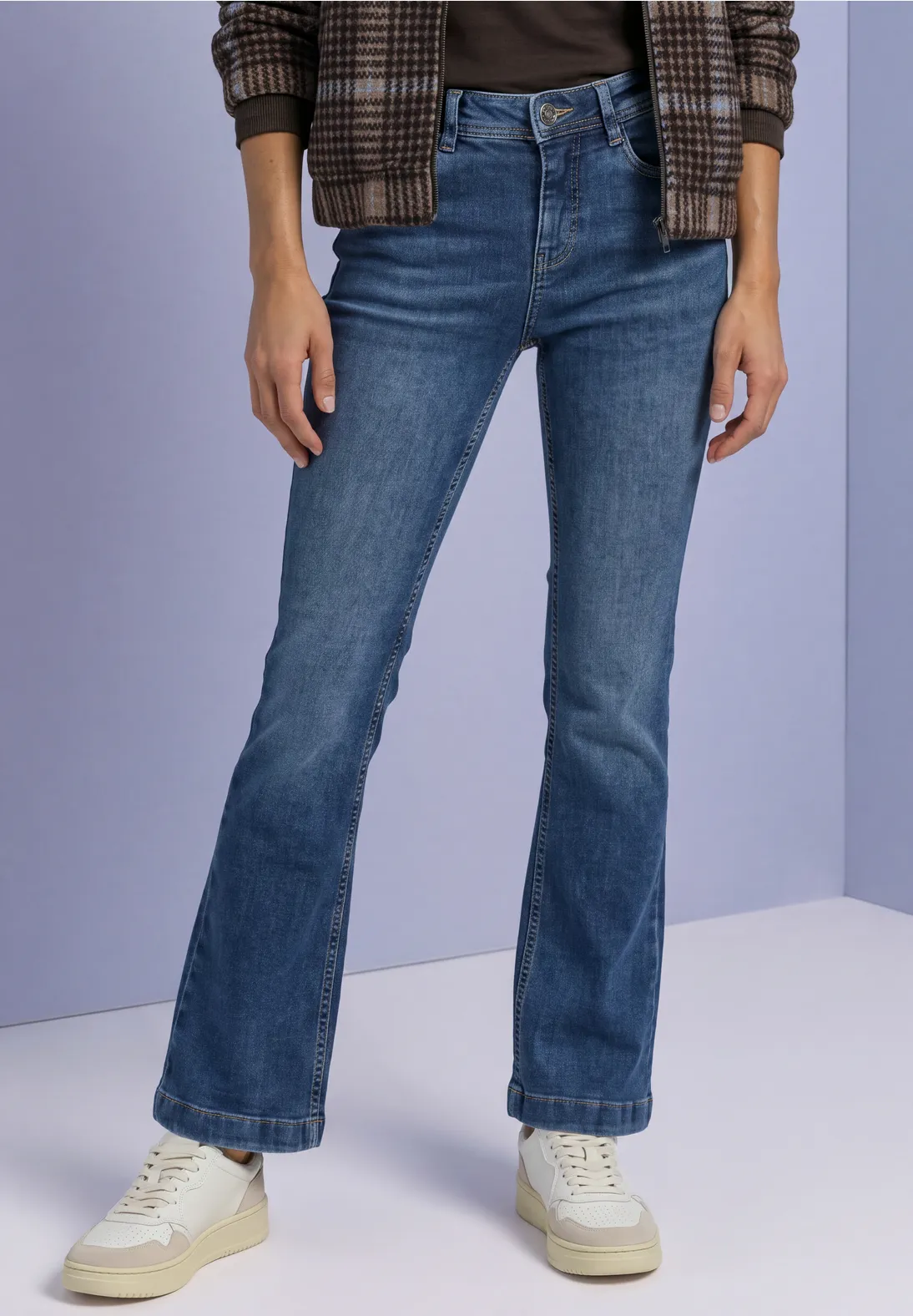 une blouse imprimée, un pull en maille, un sweat tendance, un blazer structuré, une veste en cuir, des bottines à talons, des baskets blanches, des mocassins pour une allure plus chic.